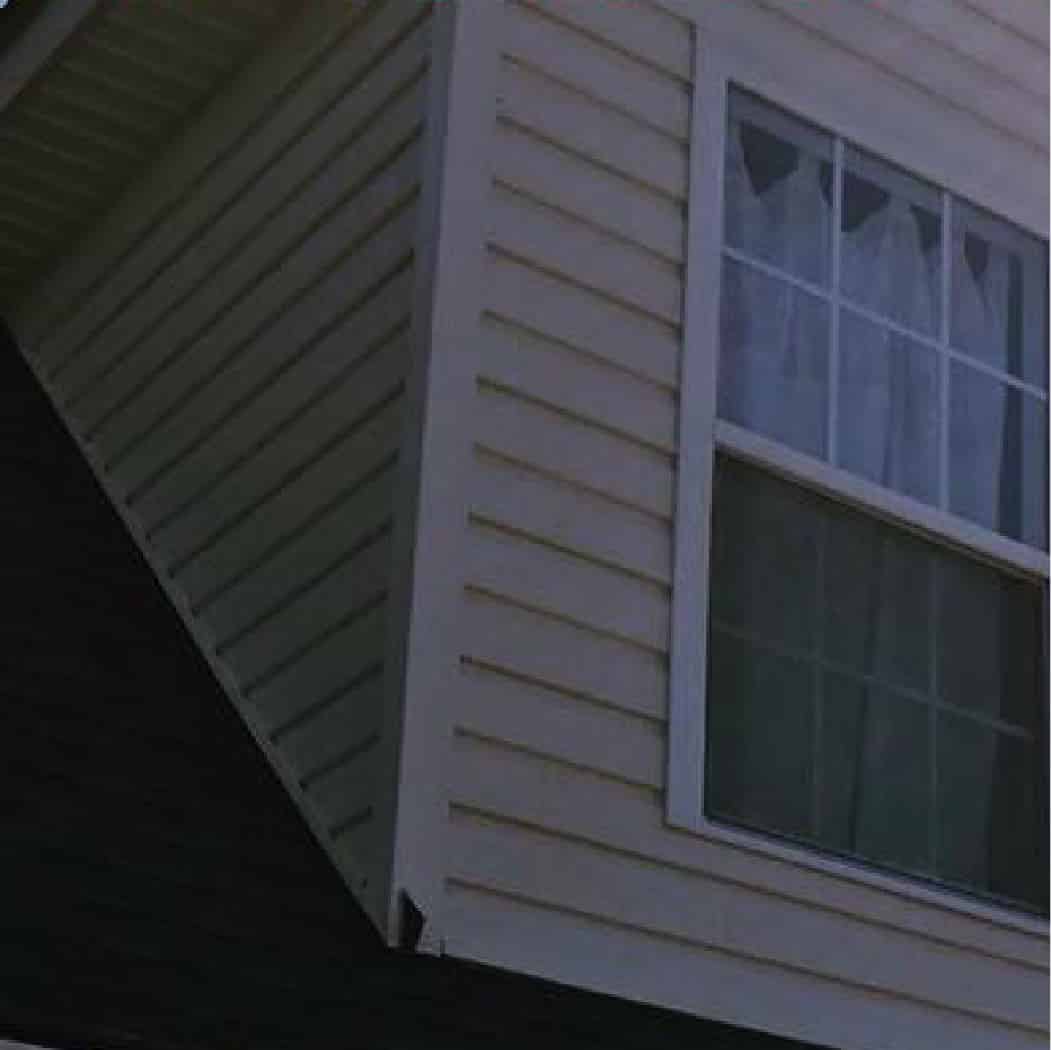 The same vinyl siding gable clean and white after a soft wash